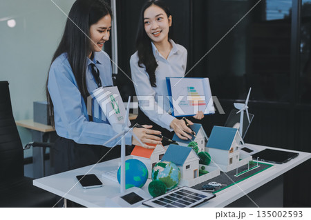 Hands of adult Asian business professionals analyzing ESG financial data and renewable energy project plans Hands of adult Asian business professionals analyzing ESG financial data and renewable energy project plans 135002593