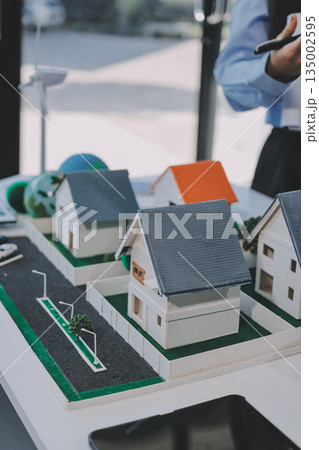 Hands of adult Asian business professionals analyzing ESG financial data and renewable energy project plans Hands of adult Asian business professionals analyzing ESG financial data and renewable energy project plans 135002595