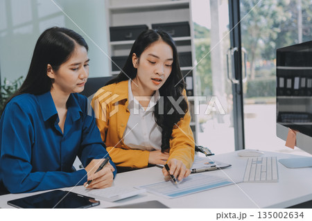 Businesswomen having discussion in office Businesswomen having discussion in office 135002634