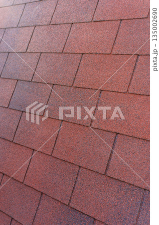 Red Bituminous Roof Shingle Texture Background with Granular Surface 135002690