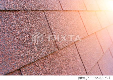 Red Bituminous Roof Shingle Texture Background with Granular Surface 135002691
