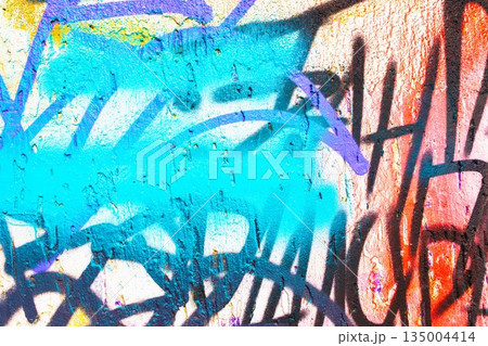 Abstract Urban Graffiti Wall with Blue, Orange, Purple Spray Paint for 2000s Street Art Style 135004414