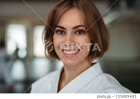 Strong woman in karate uniform. 135005483