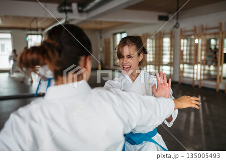 Strong women training karate in dojo. Strong women training karate in dojo. 135005493
