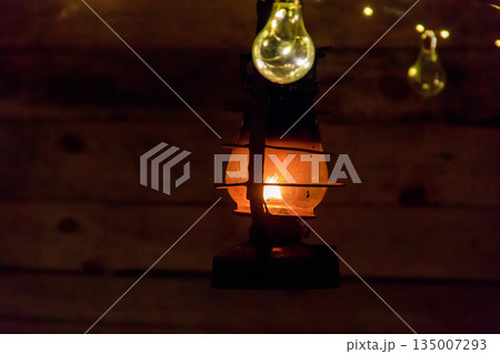 Vintage gas lamp with burning light in the night Vintage gas lamp with burning light in the night 135007293