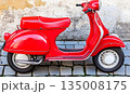 Vibrant Red Vespa Scooter Parked Against Textured Wall on Cobble 135008175