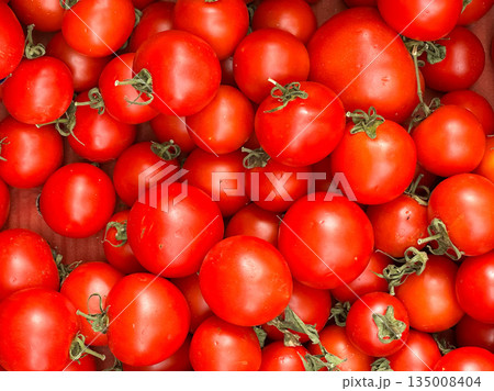A pile of vibrant red ripe tomatoes filling the frame. A pile of vibrant red ripe tomatoes filling the frame. 135008404