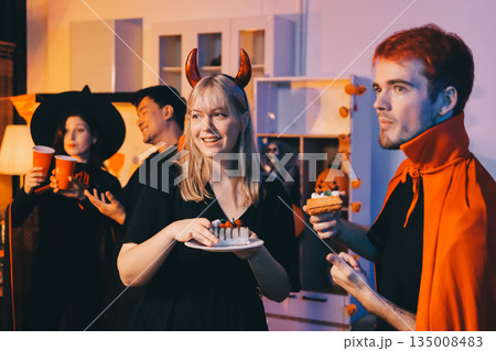 Friends enjoying a Halloween party at a bar making a toast 135008483