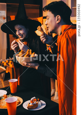Friends enjoying a Halloween party at a bar making a toast 135008492