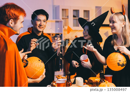 Friends enjoying a Halloween party at a bar making a toast 135008497