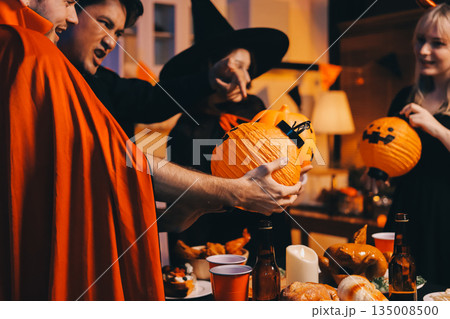Friends enjoying a Halloween party at a bar making a toast 135008500