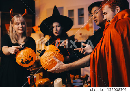Friends enjoying a Halloween party at a bar making a toast 135008501