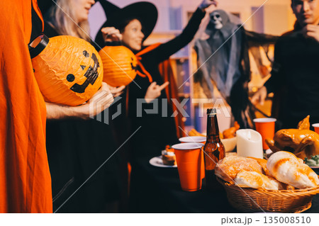 Friends enjoying a Halloween party at a bar making a toast Friends enjoying a Halloween party at a bar making a toast 135008510