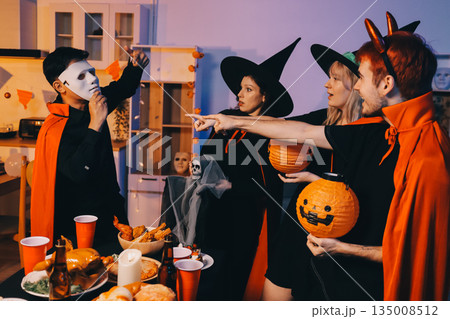 Friends enjoying a Halloween party at a bar making a toast 135008512