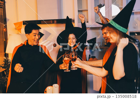 Friends enjoying a Halloween party at a bar making a toast 135008518
