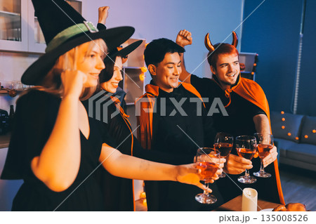 Friends enjoying a Halloween party at a bar making a toast 135008526