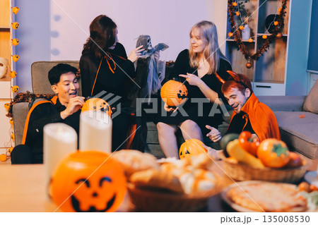Friends enjoying a Halloween party at a bar making a toast 135008530