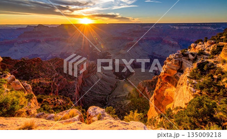 A scenic sunset and sunrise over the grand canyon in Arizona's national park reveal a majestic landscape of desert rocks, mountain clouds, and the vast scenic valley view A scenic sunset and sunrise over the grand canyon in Arizona's national park reveal a majestic landscape of desert rocks, mountain clouds, and the vast scenic valley view 135009218