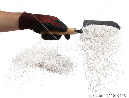 Perlite rock flying explosion, perlite white stone fall down from hand shovel garden. Perlite volcano stone splash throwing in Air. White background Isolated high speed shutter, freeze action 135010048