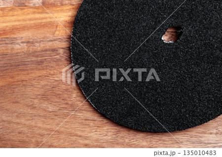 Technical water purification filter on a wooden surface. Round clean industrial part Technical water purification filter on a wooden surface. Round clean industrial part 135010483