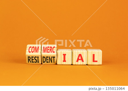 Commercial or residential symbol. Concept words Commercial or Residential on beautiful wooden blocks. Beautiful orange background. Business commercial or residential concept. Copy space. 135011064