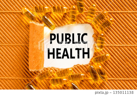 Public health symbol. Concept words Public health on beautiful white paper. Yellow pills tablets. Beautiful brown background. Medical healthy lifestyle public health concept. Public health symbol. Concept words Public health on beautiful white paper. Yellow pills tablets. Beautiful brown background. Medical healthy lifestyle public health concept. 135011138