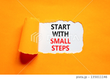 Start with small steps symbol. Concept words phrase Start with small steps on beautiful white paper. Beautiful orange paper background. Business Start with small steps concept. Copy space. 135011146