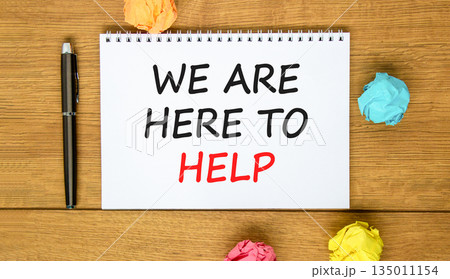 Support, help and we are here to help symbol. Concept words We are here to help on beautiful white note. Beautiful wooden background. Black pen. Business we are here to help concept. Copy space. 135011154