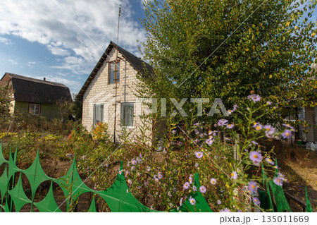 A small brick country house on a summer street. A small brick country house on a summer street. 135011669