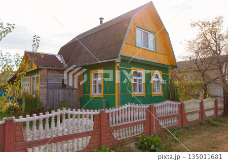 A small wooden country house on a summer street. 135011681
