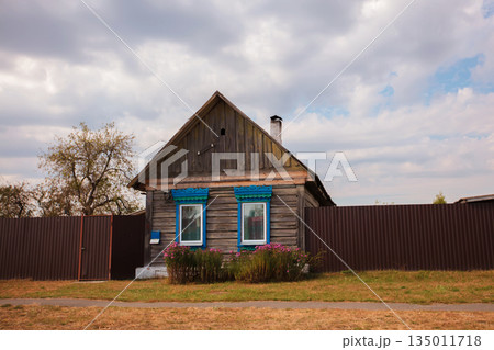 One-story Russian village house with carved shutters. One-story Russian village house with carved shutters. 135011718