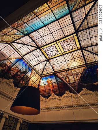The magnificent stained-glass ceiling of the Brasserie de l'Univers in Tours, France. Belle Epoque artistry glass roof is classified as Historical Monument The magnificent stained-glass ceiling of the Brasserie de l'Univers in Tours, France. Belle Epoque artistry glass roof is classified as Historical Monument 135012607