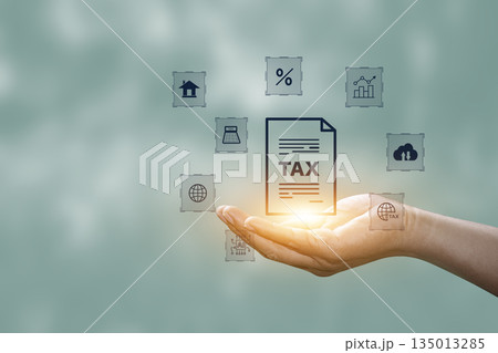 Tax increase concept. tax icon in hand. increasing taxes, Pay online income tax. income tax system icon around. futuristic virtual screen interface technology. Tax increase concept. tax icon in hand. increasing taxes, Pay online income tax. income tax system icon around. futuristic virtual screen interface technology. 135013285