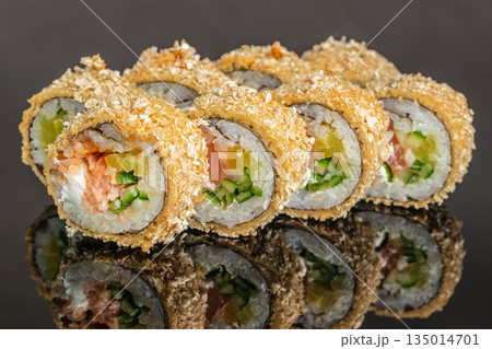 Baked sushi roll with salmon cucumber and crunchy coating close up Baked sushi roll with salmon cucumber and crunchy coating close up 135014701