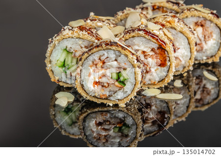 Baked sushi roll with chicken cucumber and almond flakes close up 135014702
