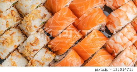 Assorted sushi set with salmon shrimp and crispy rolls top view 135014713