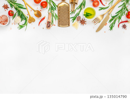 Cooking ingredients and golden kitchen utensils with herbs, spices, and vegetables on white background, top view, free space for text 135014790