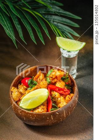 Crispy fried shrimp with chili peppers, lime, and tequila shot 135014802