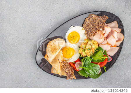 Breakfast plate with fried eggs, turkey, salad, and toast Breakfast plate with fried eggs, turkey, salad, and toast 135014843
