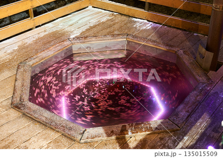 Opulent soaking experience enhanced by soft lighting and floral accents 135015509