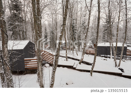 Peaceful winter setting with rustic homes and snowcovered walkways Peaceful winter setting with rustic homes and snowcovered walkways 135015515
