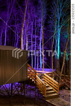 Brightly lit staircase adjacent to colorchanging trunk displays 135015535