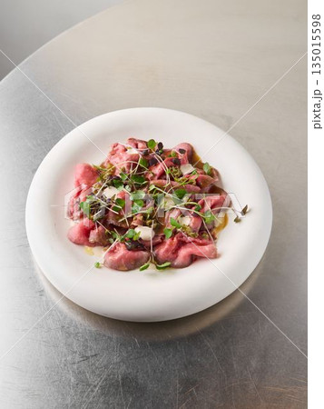 Artistic tuna carpaccio served with subtle lighting ambiance Artistic tuna carpaccio served with subtle lighting ambiance 135015598