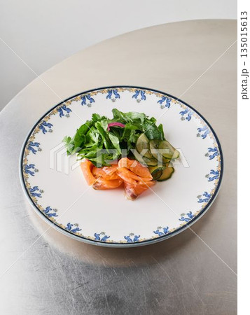 Carefully crafted presentation of smoked fish with vibrant vegetables 135015613