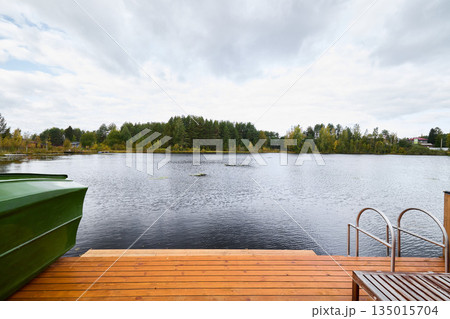 Tranquil lakeside scenery, Serene lakeside with boats and reflections 135015704
