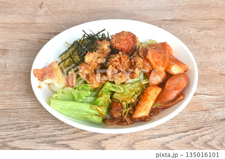 Korean vegetable noodles topping tokpokki slice pork sausage and cabbage with tofu dressing spicy sauce couple fried chicken topping dry seaweed on plate Korean vegetable noodles topping tokpokki slice pork sausage and cabbage with tofu dressing spicy sauce couple fried chicken topping dry seaweed on plate 135016101