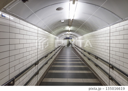 Empty White Tiled Underground Pedestrian Tunnel Empty White Tiled Underground Pedestrian Tunnel 135016619