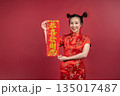 Portrait of young woman with lucky red banner for Lunar New Year greeting Portrait of young woman with lucky red banner for Lunar New Year greeting 135017487