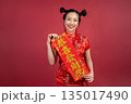 Portrait of beautiful woman celebrating Lunar New Year with festive banner Portrait of beautiful woman celebrating Lunar New Year with festive banner 135017490