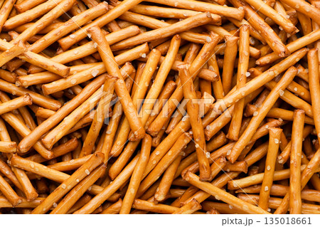 Pretzel sticks with salt background. Top view 135018661